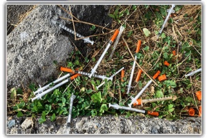 Lots of needles on ground from encampment